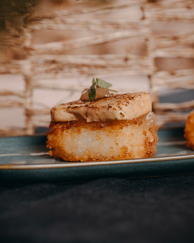 A block of crispy rice topped with a seared escalope of foie gras.